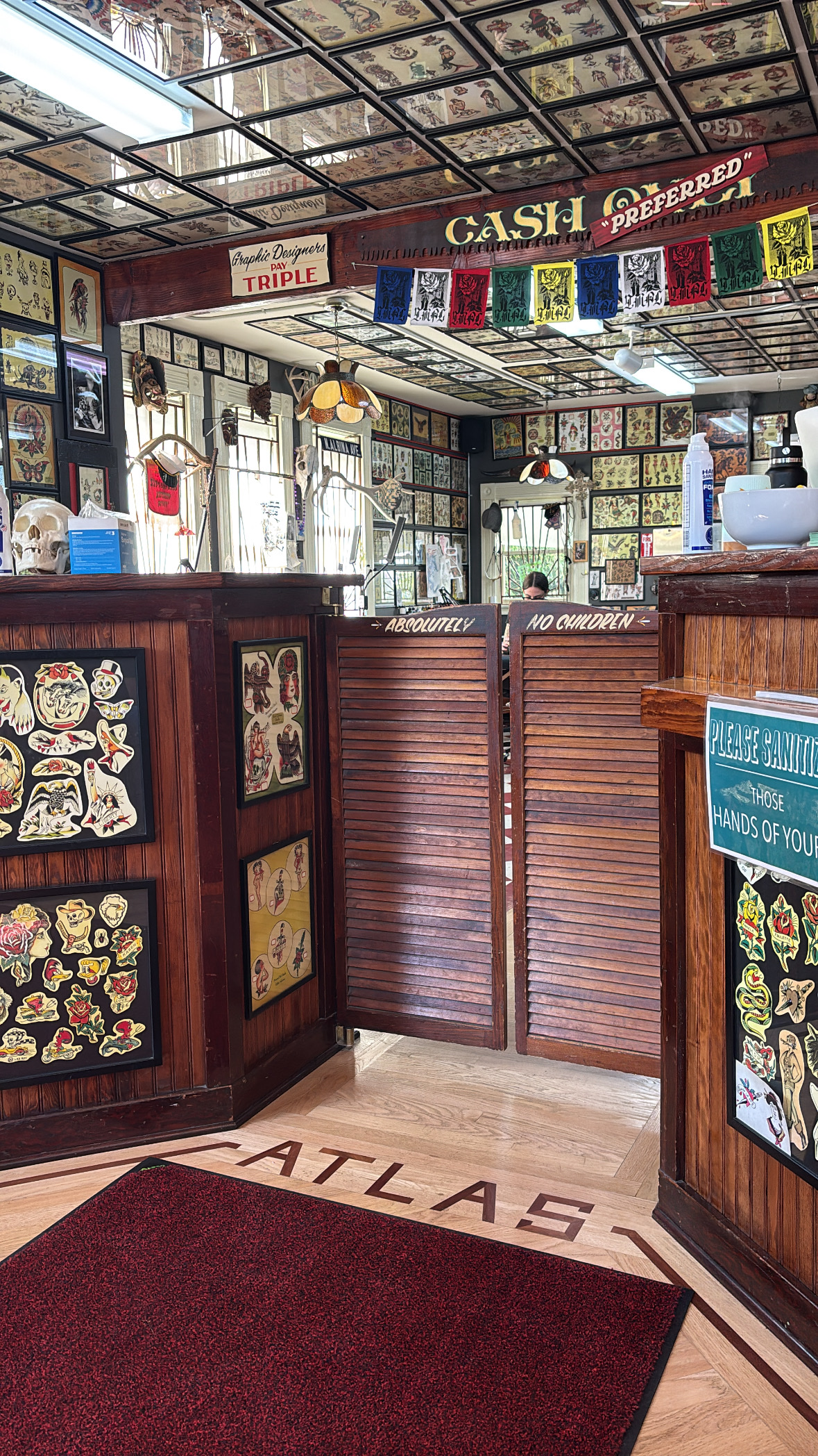 Atlas Tattoo Studio workspace and flash wall